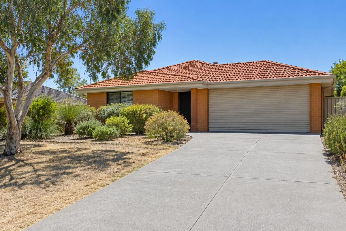Illustrative image: plain concrete driveway at a brick-and-tile single-storey Perth home