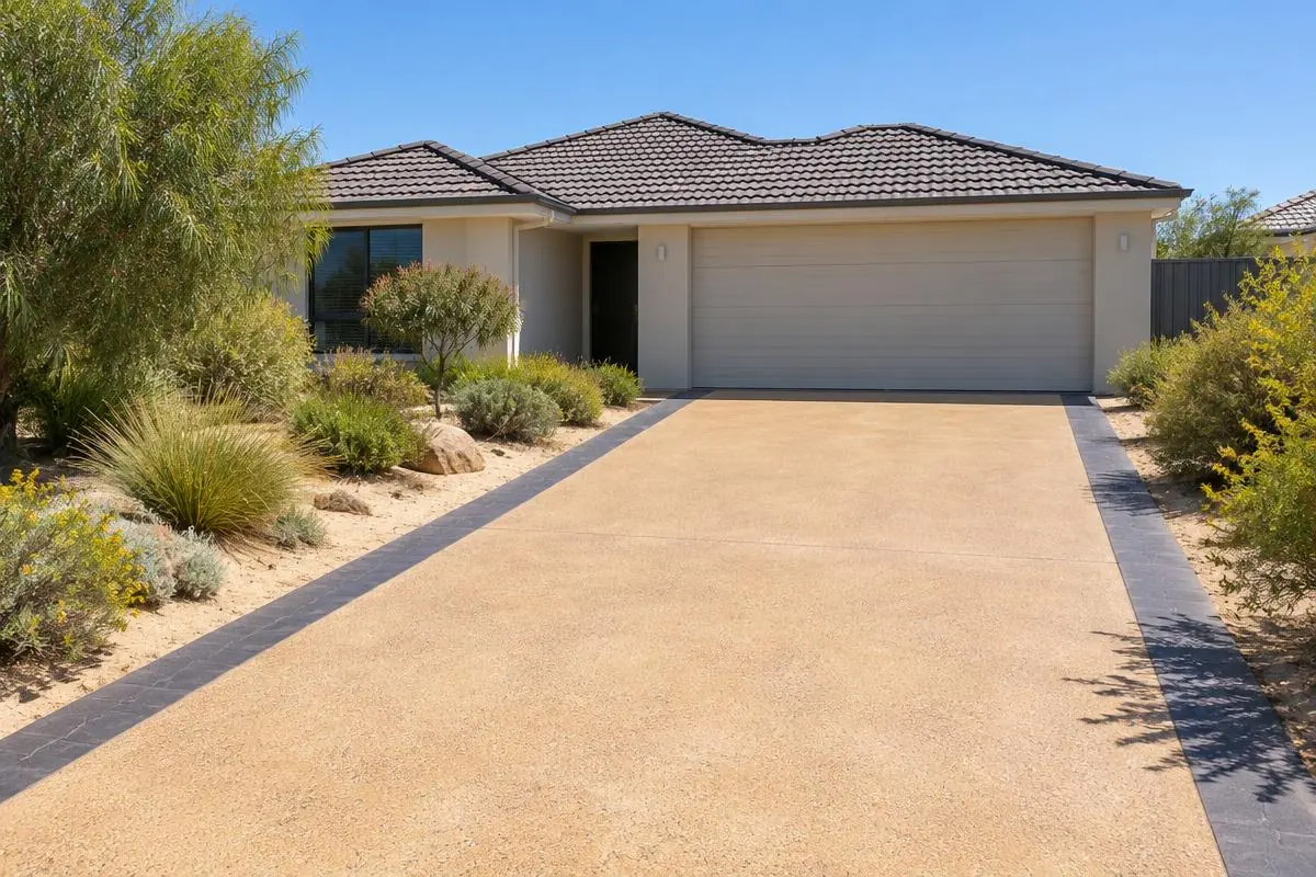 Illustrative image: sandstone-coloured decorative concrete driveway with a contrasting charcoal border
